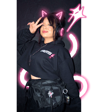 a girl wearing a black hoodie and pink headphones