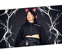 a woman wearing a black hoodie and pink cat ears