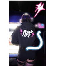 a girl wearing a hoodie with a neon sign on it