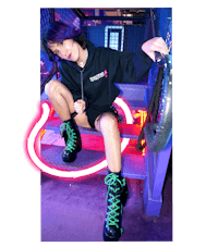 a girl wearing neon green boots and a hoodie